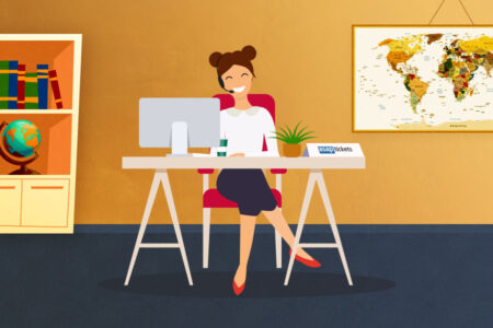 A female travel agent sitting at a desk wearing a headset with a computer and a world map in the background. How to use a travel agent - Book with ASAP Tickets Travel Agency